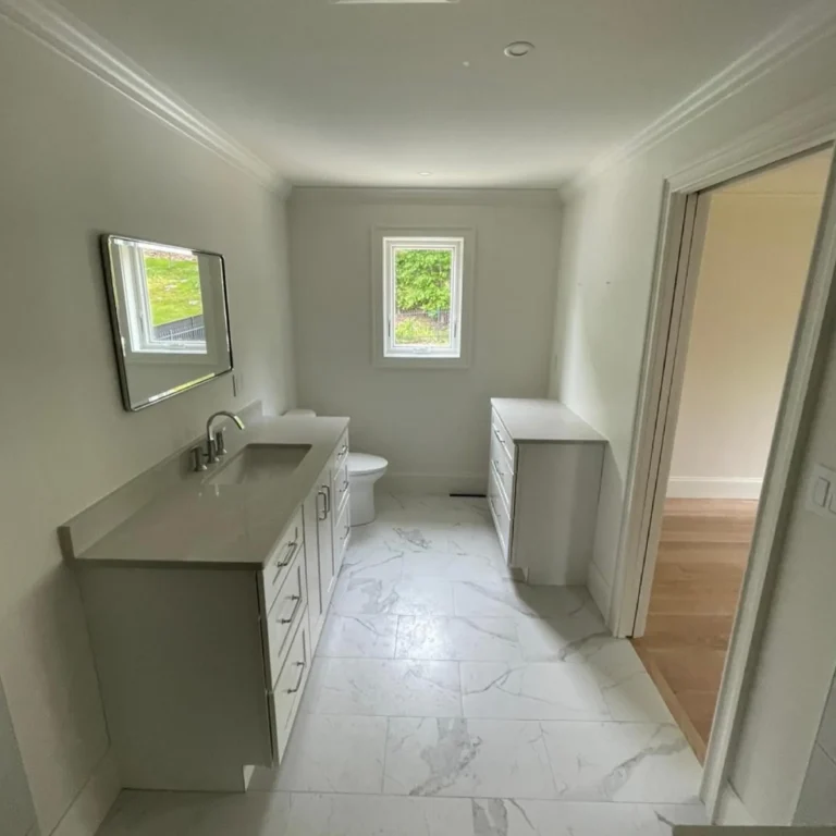 Cozy bathroom with a light gray stone tile in the floor.