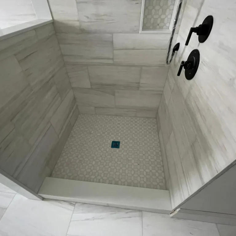 Gray light stone tile in a shower.