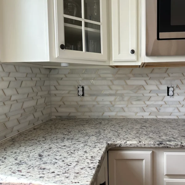Modern tile with golden metal and stone backsplash